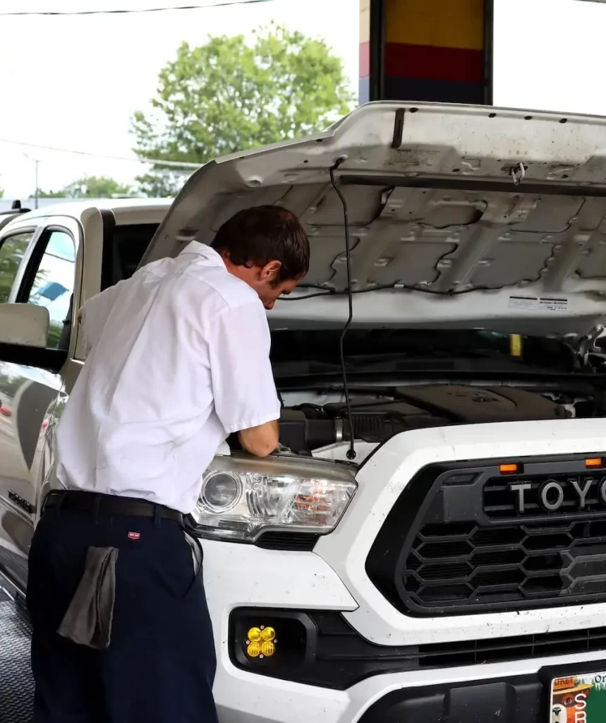 Technician working on oil change in Eugene